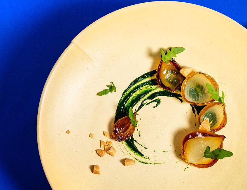 Cebollas asadas con salsa de rúcula y almendras tostadas